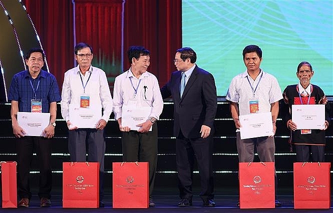 Thủ tướng Phạm Minh Chính trao kỷ vật cho thân nhân liệt sĩ. Ảnh: Dương Giang/TTXVN