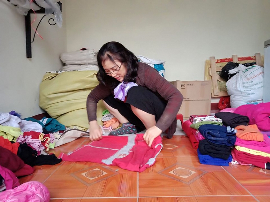 Bà Đức phân loại, đóng gói quần áo làm từ thiện.