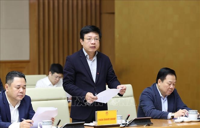 Phó Chủ tịch Uỷ ban Quản lý vốn Nhà nước tại doanh nghiệp Hồ Sỹ Hùng báo cáo tình hình sản xuất, kinh doanh. Ảnh: Dương Giang/TTXVN