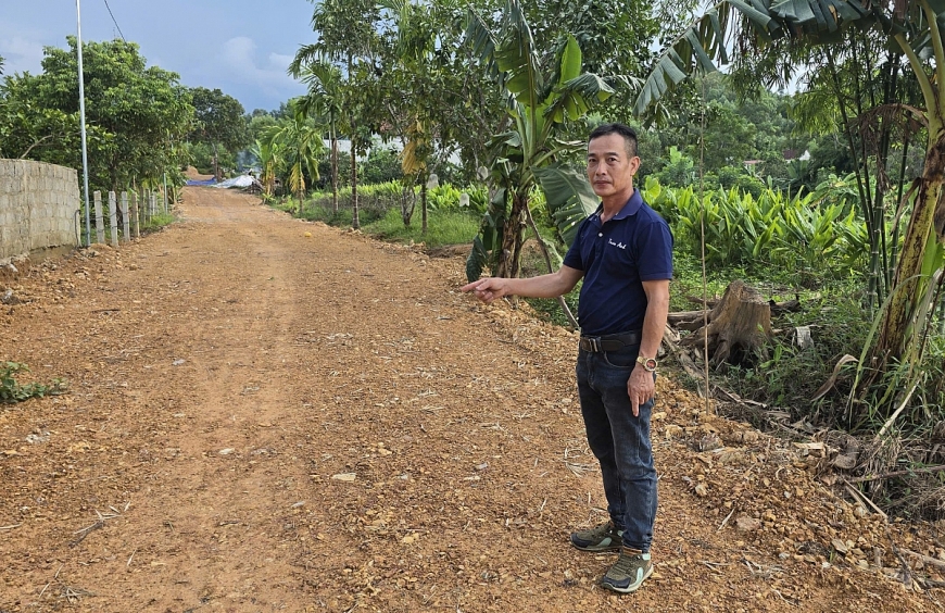 Bà Nguyễn Thị Vường và ông Nguyễn Thái Sơn, Phó Bí thư Chi bộ thôn Khe Thờ bên cạnh con đường mới mở qua nhà anh Thuyết.