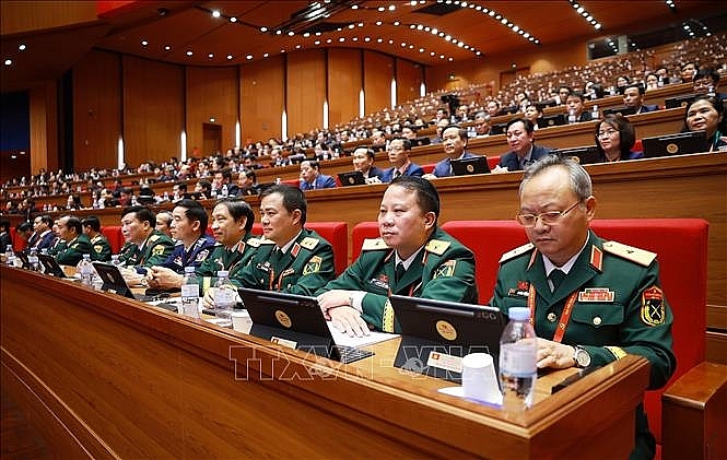 Đoàn đại biểu Đảng bộ Quân đội dự phiên thảo luận tại hội trường về các văn kiện Đại hội chiều 21/1. Ảnh: TTXVN