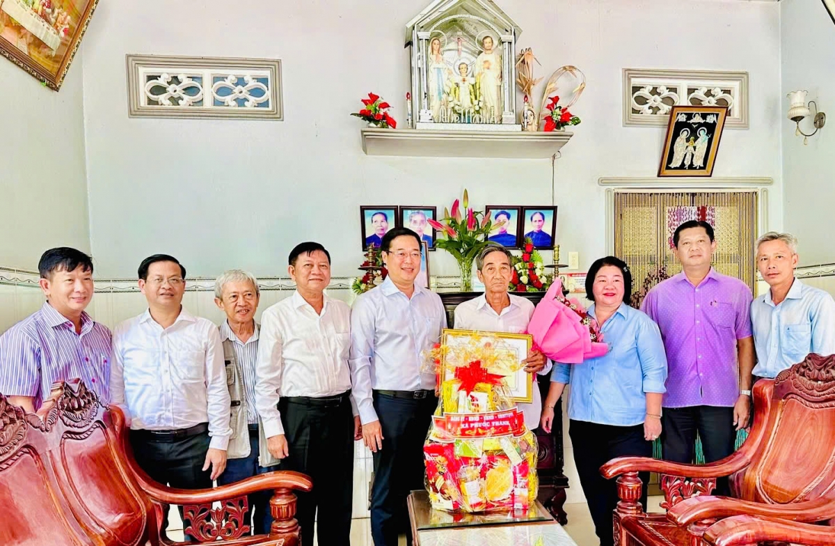 Lãnh đạo TP. Hồ Chí Minh và lãnh đạo địa phương chụp ảnh lưu niệm cùng cụ Nguyễn Văn Tân và gia đình.