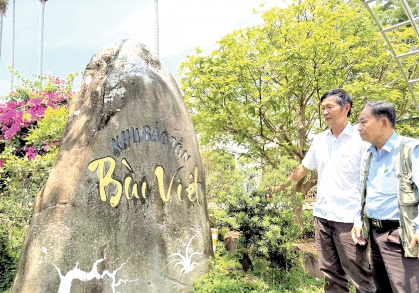 Ông Bùi Quốc Việt (trái) giới thiệu về Khu bảo tồn lan Bùi Việt.