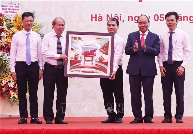 Chủ tịch nước Nguyễn Xuân Phúc tặng quà lưu niệm cho Trường THPT Chuyên Khoa học Tự nhiên. Ảnh: Thống Nhất/TTXVN