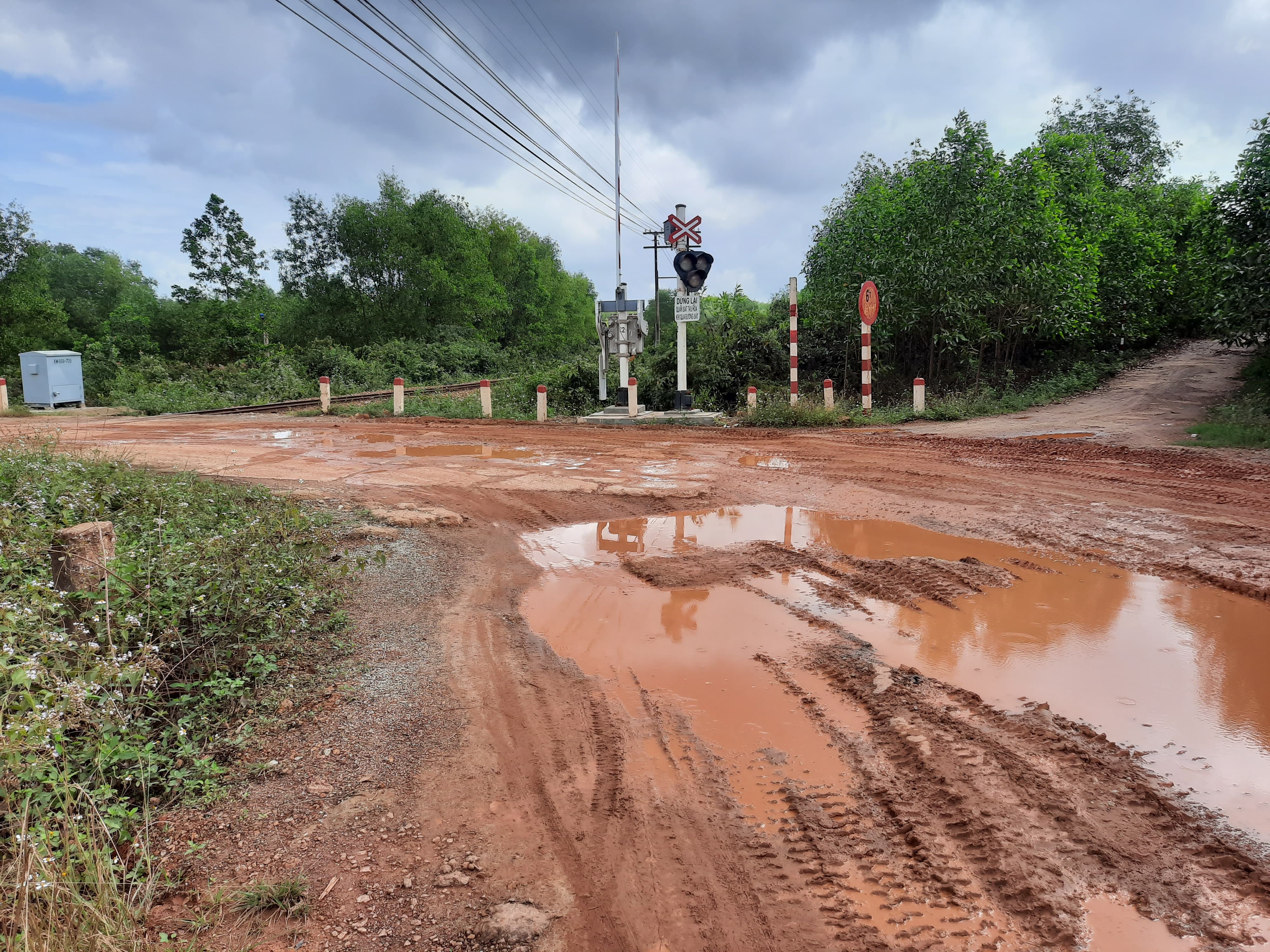 Đoạn đường ngang được phủ b&ecirc; t&ocirc;ng đ&atilde; bị nứt to&aacute;c, xuống cấp nặng nề v&igrave; phải g&aacute;nh nhiều xe chở đất.