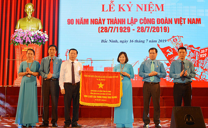 B&iacute; thư Tỉnh ủy Nguyễn Nh&acirc;n Chiến (b&ecirc;n trái) trao tặng Cờ thi đua của Ch&iacute;nh phủ cho LĐLĐ tỉnh. (Ảnh: Báo Bắc Ninh)