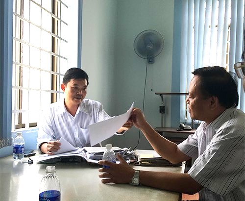 &Ocirc;ng Nguyễn Hữu Phước (tr&aacute;i) v&agrave; Nguyễn Văn Nghĩa (phải) c&aacute;n bộ Chi cục THADS huyện Củ Chi hướng dẫn &ocirc;ng Tuyển, kh&ocirc;ng n&ecirc;n nộp tiền trực tiếp cho ng&acirc;n h&agrave;ng