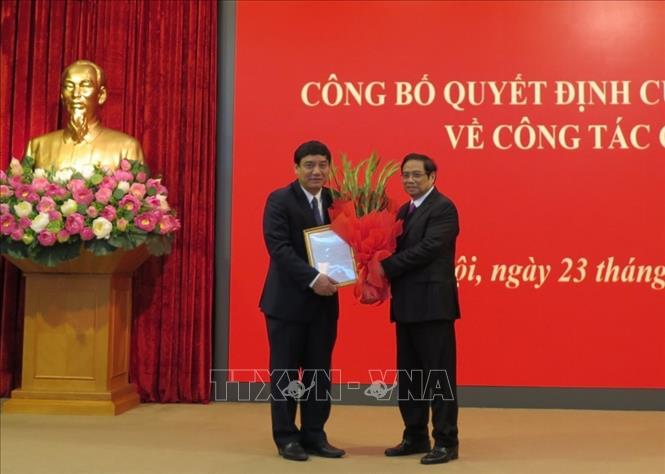 Đồng ch&iacute; Phạm Minh Ch&iacute;nh, Ủy vi&ecirc;n Bộ Ch&iacute;nh trị, B&iacute; thư Trung ương Đảng, Trưởng Ban Tổ chức Trung ương trao quyết định của Bộ Ch&iacute;nh trị v&agrave; tặng hoa ch&uacute;c mừng đồng ch&iacute; Nguyễn Đắc Vinh. Ảnh: Văn Điệp/TTXVN