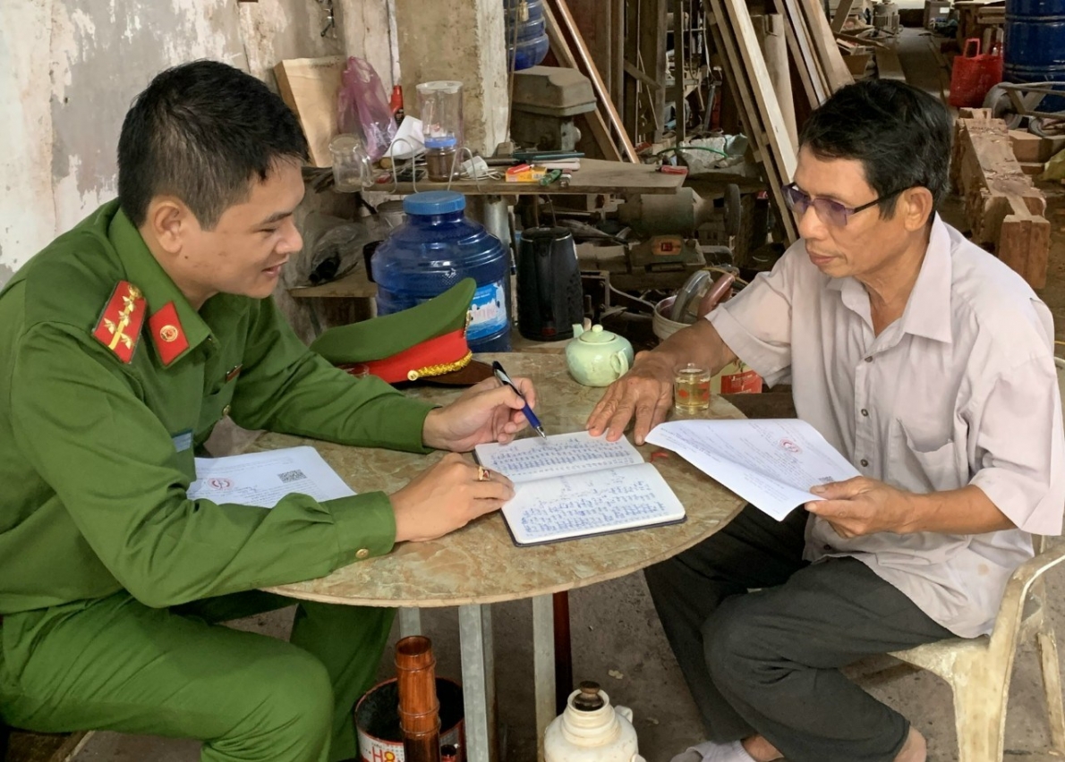 Ông Nguyễn Văn Khải trao đổi công việc với cán bộ Công an xã