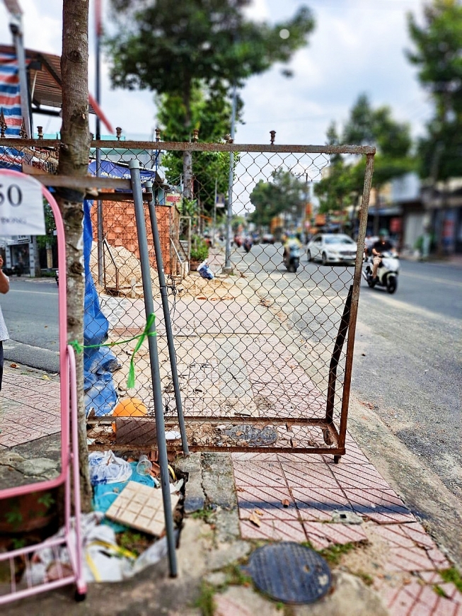 Hàng rào chiếm hết lề đường.